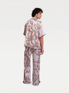 a male model standing back in a pajama match set 