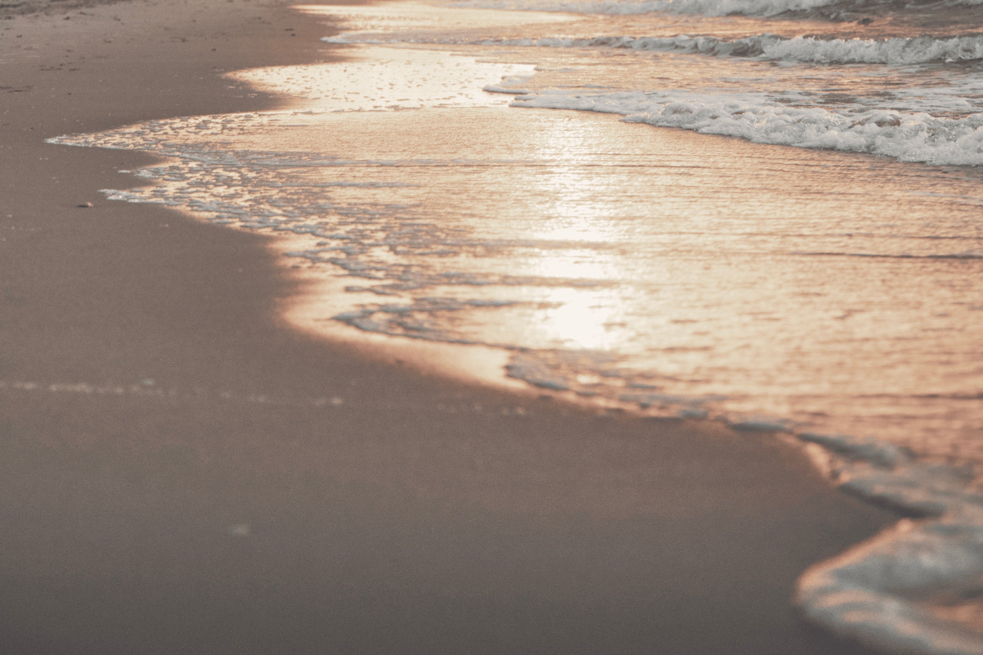 A scenic beach with rolling waves and golden sand